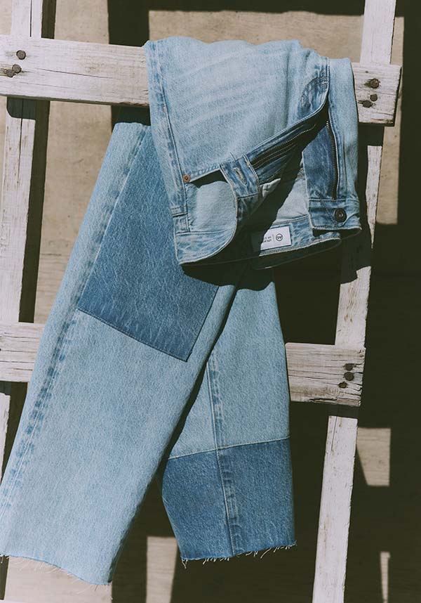 Denim jeans draped over a wooden chair