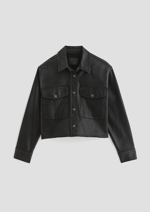 A black cropped denim jacket with a button-up front, two chest flap pockets, and long sleeves, shown flat against a light gray background.