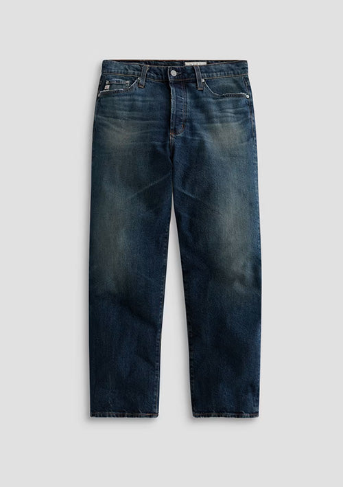A pair of dark blue denim jeans with a faded wash, shown flat against a light gray background.