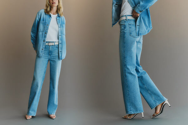 Two people wearing matching blue denim outfits on a neutral background