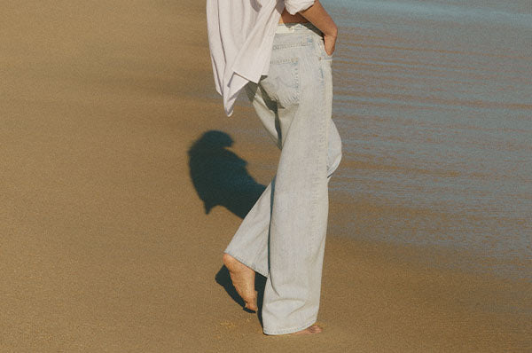 Man wearing a green shirt and blue jeans 