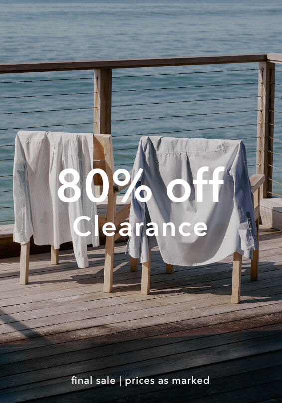 Two chairs with cloths draped over them on a wooden deck by the ocean, with '80% off Clearance' text overlay.