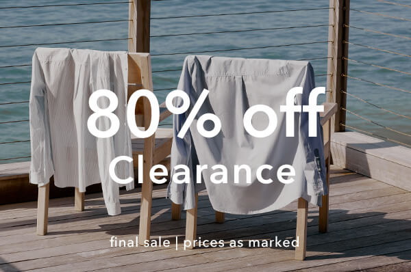 Two chairs with cloths draped over them on a wooden deck by the ocean, with '80% off Clearance' text overlay.