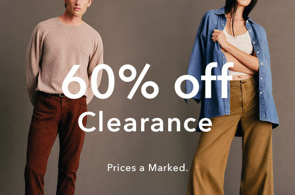 Promotional banner for a clothing clearance sale showing a man in a beige sweater and brown pants on the left, and a woman in a blue button-up shirt over a white top and tan pants on the right, with large white text reading '60% off Clearance' and smaller text 'Prices a Marked.' on a taupe background.