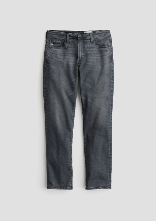 A pair of dark gray washed denim jeans shown flat against a light gray background.
